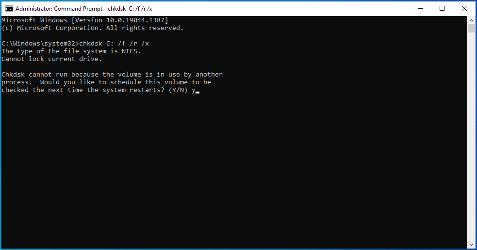 You'll see "Chkdsk cannot run because the volume is in use by another process. Would you like to schedule this volume to be checked the next time the system restarts? (Y/N)".